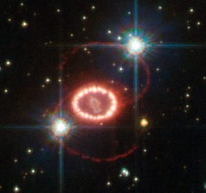 Particle detectors were able to record a few of the enormous number of neutrinos emitted by supernova SN1987A, here shown in a Hubble Space Telescope photo.